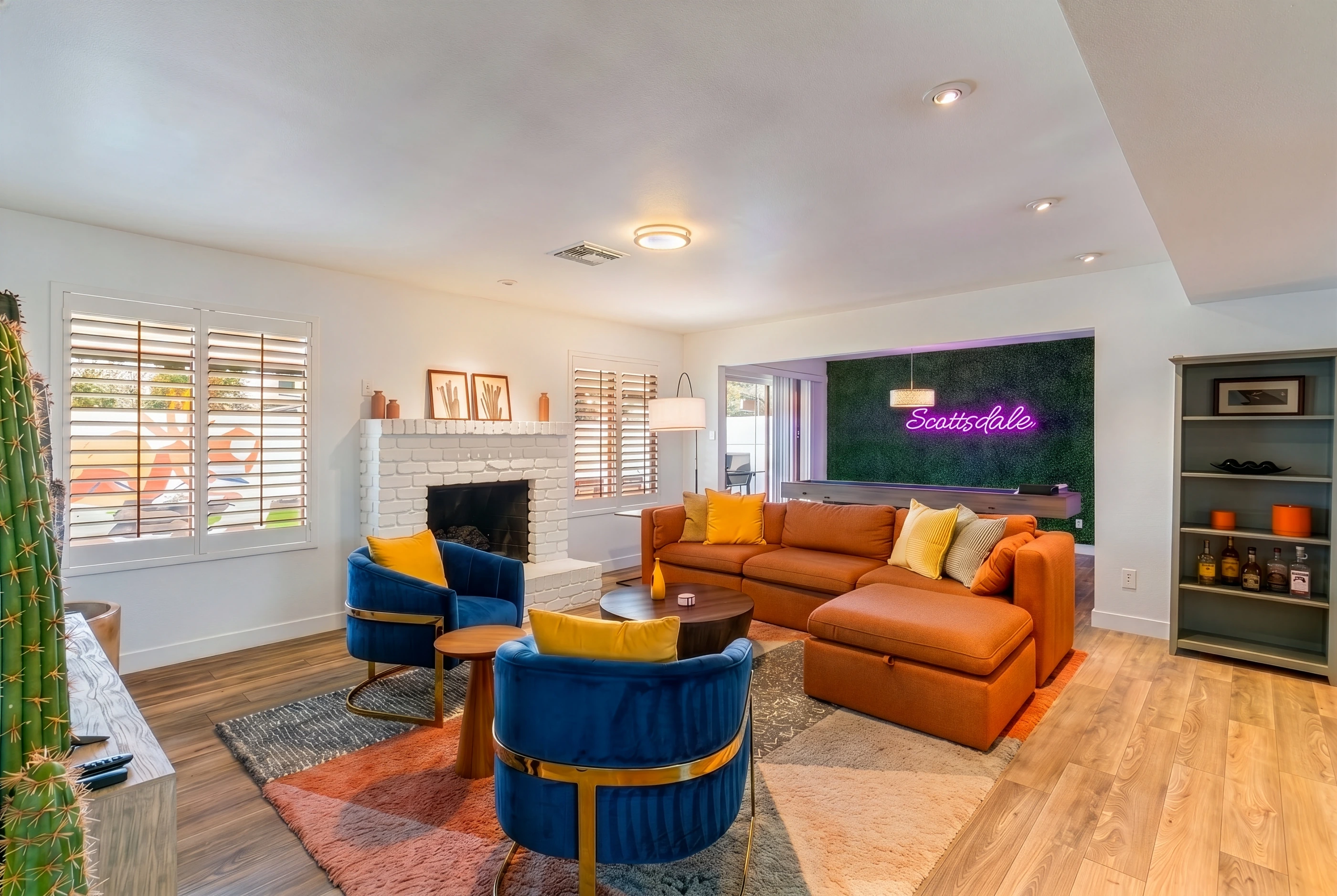 El Charro Sol living room with fireplace, colorful seating, and adjacent game room