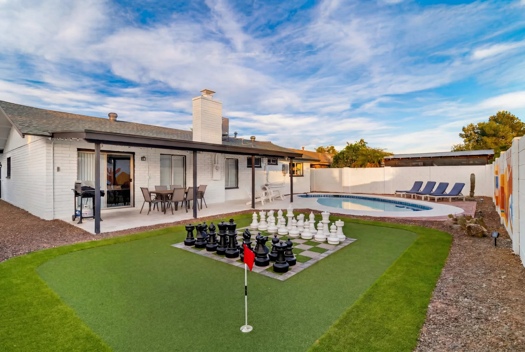 El Charro Sol backyard with putting green and giant chess